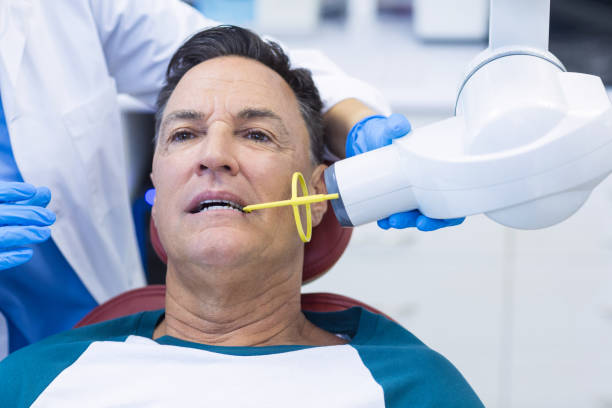 istock Dentist examining a male patient with tool 676967496