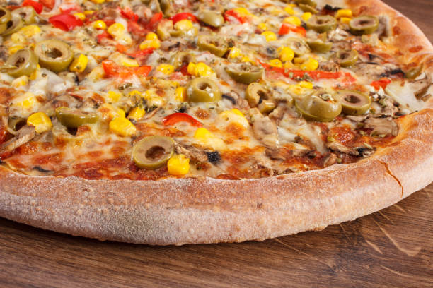 istock Vegetarian pizza on rustic wooden background, fast food 676991158