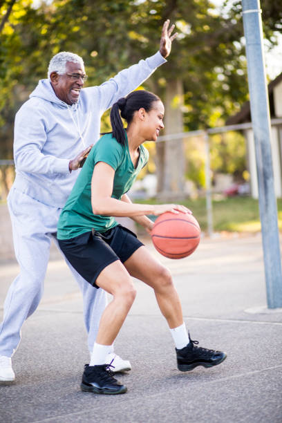 istock Father and Daughter Playing Basketball 677012510