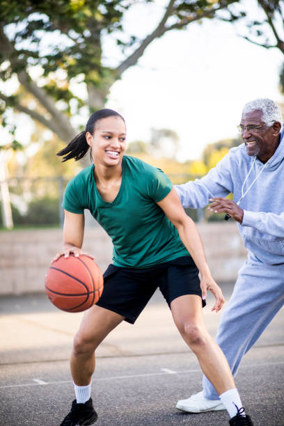 istock Father and Daughter Playing Basketball 677012698