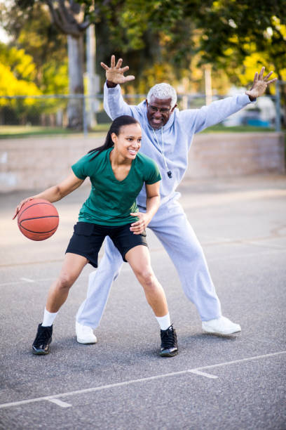 istock Father and Daughter Playing Basketball 677012702