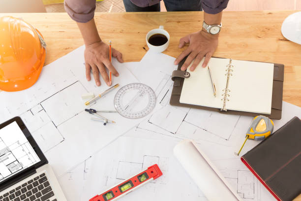 istock Architect concept, Architects working with blueprints in the office 677012860