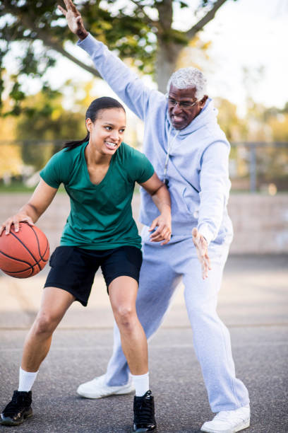 istock Father and Daughter Playing Basketball 677012970