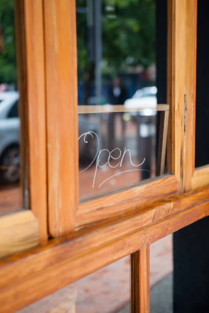 istock Open text on glass window of side walk cafe 677024316