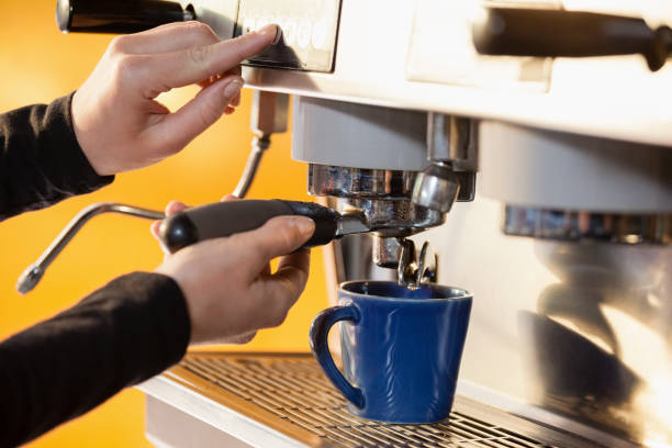 istock Cropped image of woman making coffee 677046276