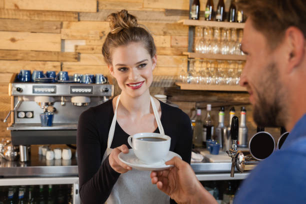 istock Smiling owner giving coffee to customer 677047186