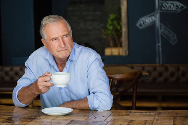 istock Thoughtful senior man holding coffee cup 677068548