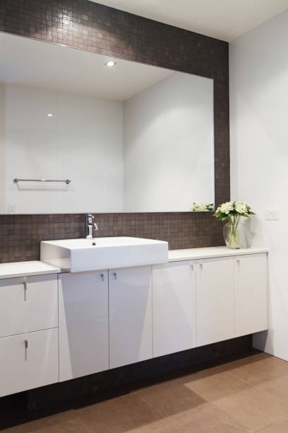 istock Clean white bathroom with mosaic rustic splashback in contemporary home 677100362