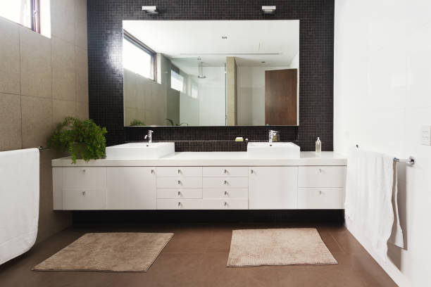 interior of bathroom with mirror reflection and sink basin
