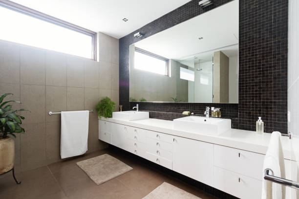 istock Black mosaic tiled splashback and double basin bathroom 677104996