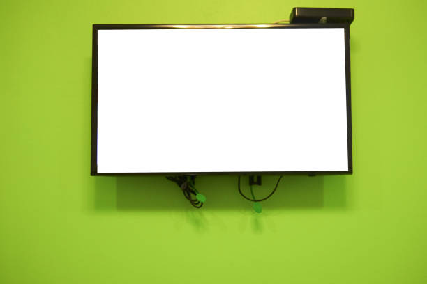 istock Blank LCD TV hanging at the green wall in home 677105492