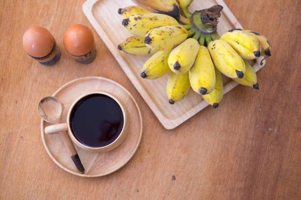 istock Healthy breakfast. Soft-boiled egg and banana with hot coffee 677105538