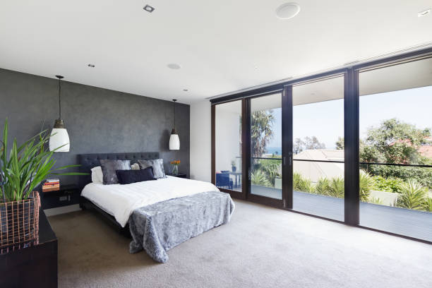 Spacious interior of designer master bedroom in luxury Australian home Spacious interior of designer master bedroom in luxury contemporary Australian home balcony photos stock pictures, royalty-free photos & images