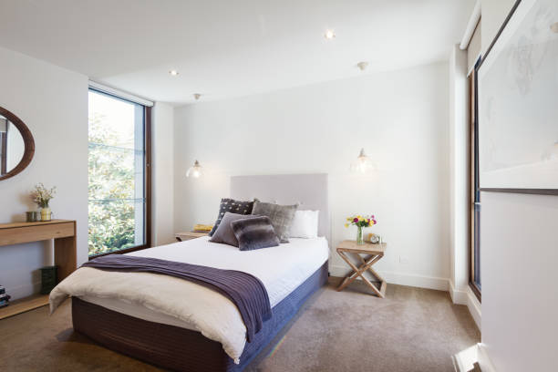 Luxury interior designed bedroom with comfy pillows and throw rug