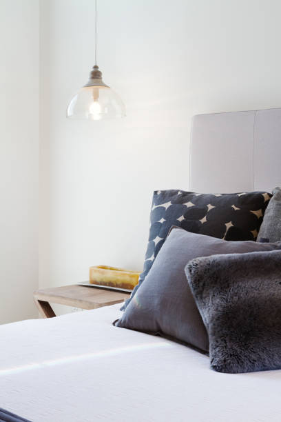 Luxury bedroom details of dark grey throw pillows