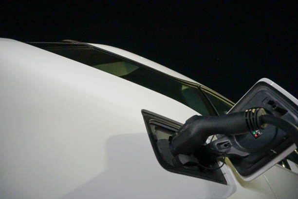 An electric car charging at night.