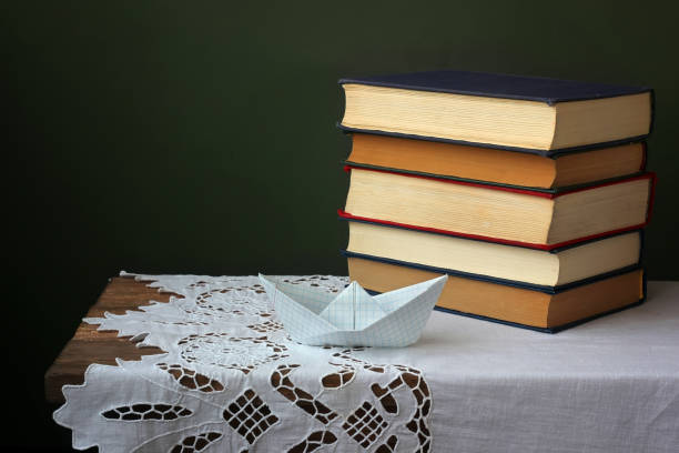 istock Pile of books on a wooden table. 677147216