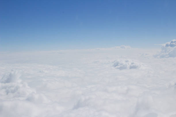 istock blue sky high view from airplane clouds shapes 677158282