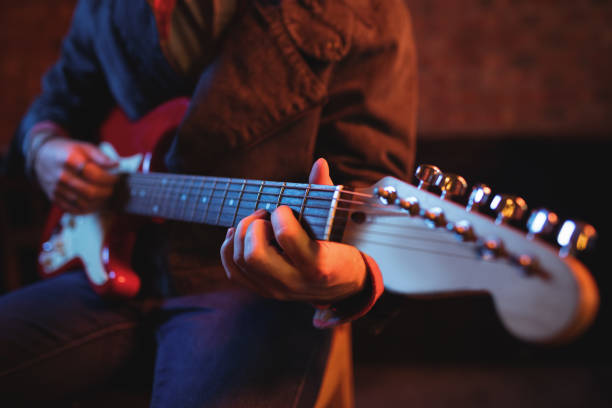 istock Mid-section of man playing guitar 677159838