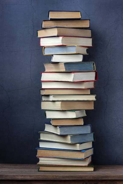 istock Pile of books on a wooden table. 677167624