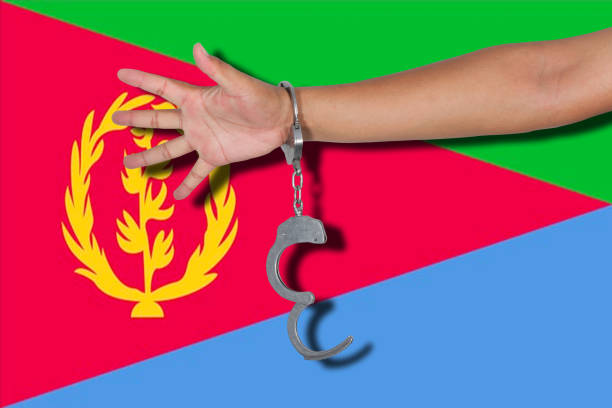 istock handcuffs with hand on Eritrea flag 677190558