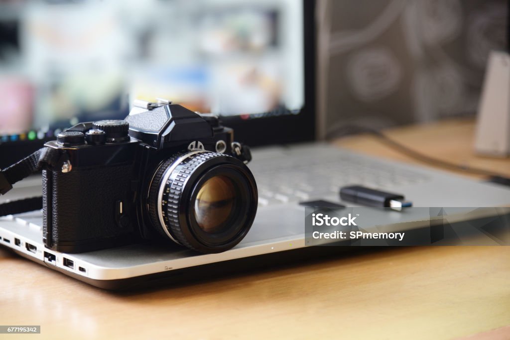 Digital Studio Photography Workstation. Retro film DSLR Camera, Laptop Computer Screen and flash drive memory card Camera - Photographic Equipment Stock Photo