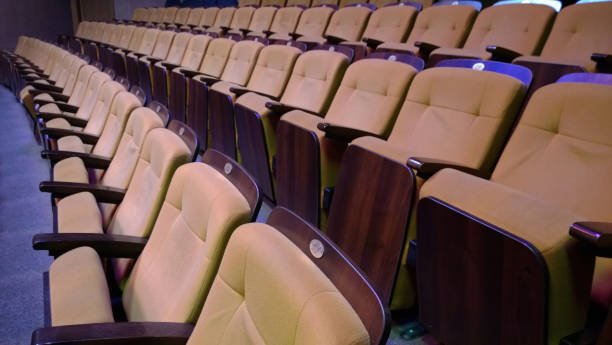 istock Several rows of folding comfortable padded seats in the theater 677204360