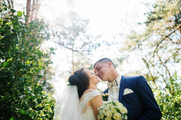 istock Loving young wedding couple in love at sunny forest. 677239652