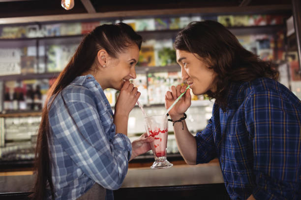 istock Happy couple having milkshake at counter 677240874