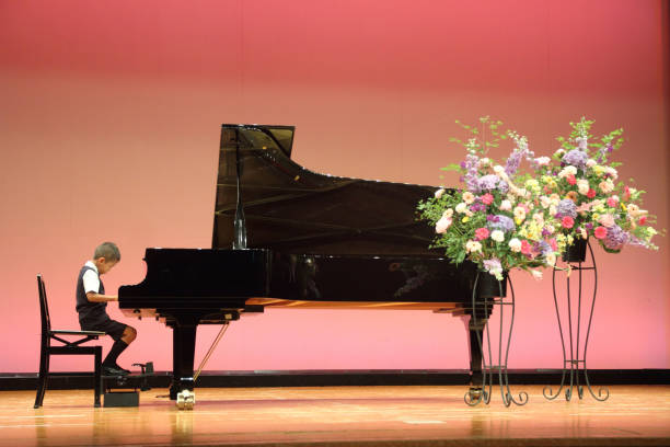 istock Japanese boy playing a piano (first grade at elementary school) 677242078