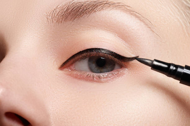 istock Beautiful model applying eyeliner close-up on eye 677263682
