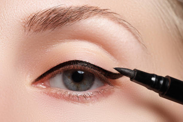 istock Beautiful model applying eyeliner close-up on eye 677263702