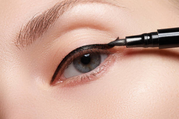istock Beautiful model applying eyeliner close-up on eye 677263704