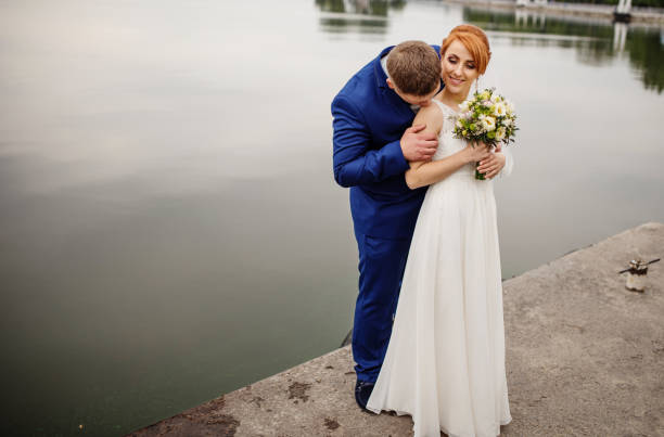 istock Wedding couple background lake on cloudy day. 677264054