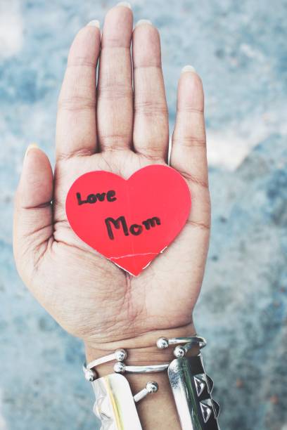 istock Woman with heart mom on hand 677267398