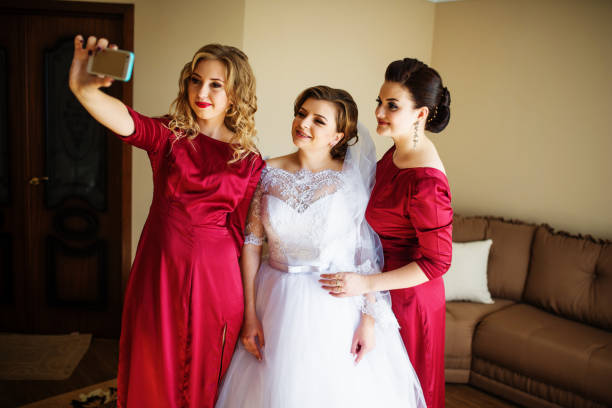 istock Bride with bridesmaids making selfie at wedding day. 677275220