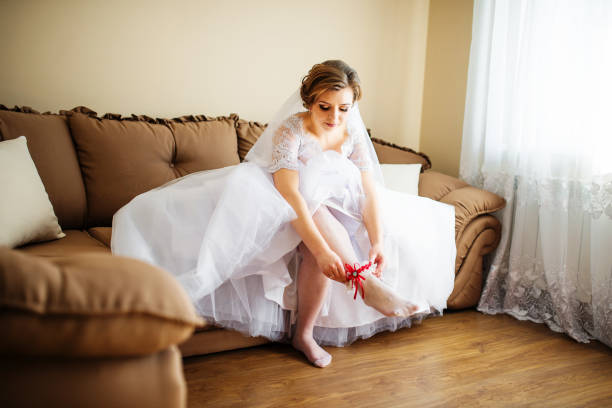istock Bride wear red garter on leg at wedding day. 677276256