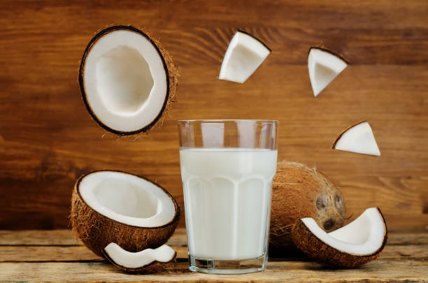 istock Coconut milk with coconuts and flying slices 677276712