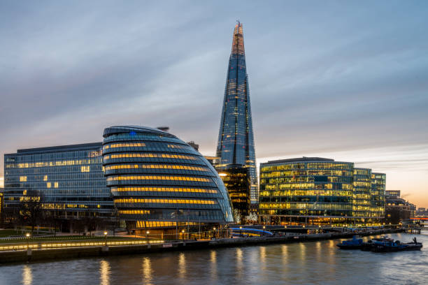 London Cityscape The Shard and River Thames at Twilight London Cityscape, view from Tower Bridge over River Thames to the Illuminated Buildings and the Shard at the Riverside. London, United Kingdom. gla building stock pictures, royalty-free photos & images