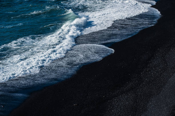 Black sand beach with wave Black sand beach with wave black sand stock pictures, royalty-free photos & images