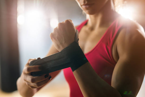 istock Unrecognizable athlete applying adhesive bandage on hand before boxing training. 677288098