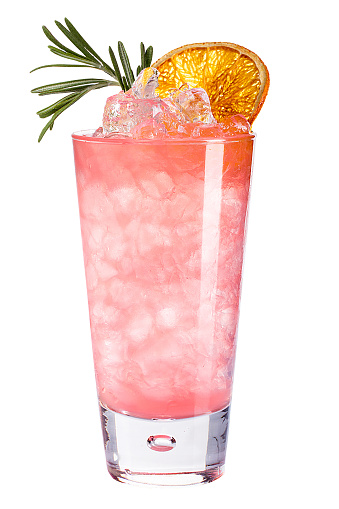 Refreshing cold pink cocktail with ice decorated with dried orange and rosemary. isolated
