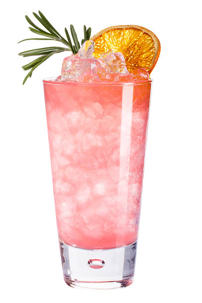 Refreshing cold pink cocktail with ice decorated with dried orange and rosemary. stock photo