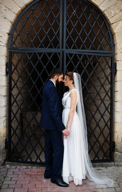 istock Wedding couple near old wrought iron gates. 677326692
