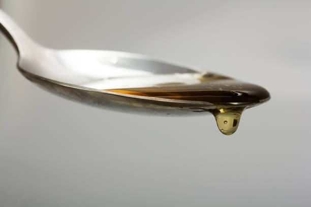 istock Honey pouring from spoon against a light background 677341588