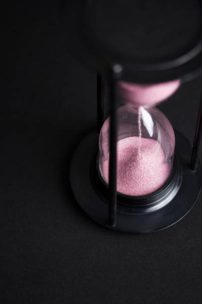 istock Large black hourglass against a black background 677342920