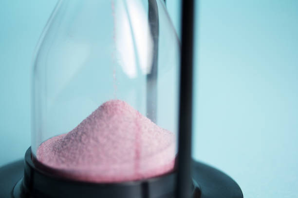 istock Large black hourglass against a blue background 677342922