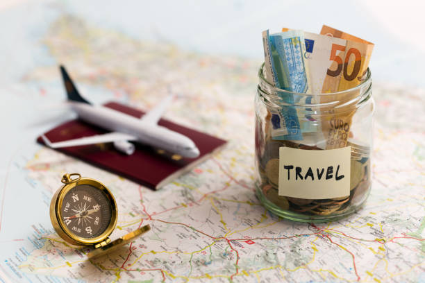 istock travel concept - money savings, compass and passport on a map 677356680