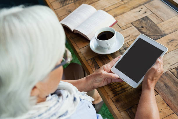 istock Close up of woman using tablet on table 677365146