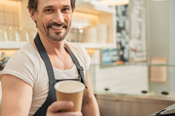 istock Joyful man working in coffee house 677391710